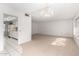Bright living room with chandelier,carpet, and view into kitchen at 9719 W Newport Dr, Sun City, AZ 85351