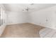 Spacious living room featuring ceiling fan and neutral carpeting at 9719 W Newport Dr, Sun City, AZ 85351