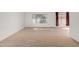 Carpeted living room with large window and view to backyard at 9719 W Newport Dr, Sun City, AZ 85351