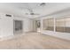 Living area with sliding door access to patio and view into dining area at 9719 W Newport Dr, Sun City, AZ 85351