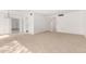 Bright living room with carpeted floors and access to other rooms at 9719 W Newport Dr, Sun City, AZ 85351