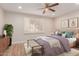 Cozy bedroom with a ceiling fan, window with wooden blinds, and wood flooring at 10450 W Campana Dr, Sun City, AZ 85351