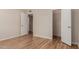 Bedroom with wood-look flooring and mirrored closet doors at 10450 W Campana Dr, Sun City, AZ 85351