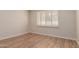 Well-lit bedroom with wood-look floors and window shutters at 10450 W Campana Dr, Sun City, AZ 85351