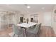 Bright dining room featuring a modern table with seating for six and sliding door access to the porch at 10450 W Campana Dr, Sun City, AZ 85351