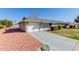 View of the home's exterior, showcasing the garage and landscaping at 10450 W Campana Dr, Sun City, AZ 85351