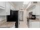 Modern kitchen with stainless steel appliances and white cabinets at 10450 W Campana Dr, Sun City, AZ 85351