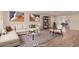 Bright living room featuring a large sectional sofa, modern art, and an open floor plan at 10450 W Campana Dr, Sun City, AZ 85351