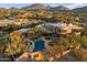 Expansive desert estate with a backyard pool and lush landscaping against mountain views at 10801 E Happy Valley Rd # 102, Scottsdale, AZ 85255