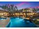 Backyard with pool, patio, outdoor lighting and desert landscaping creating an inviting space for entertainment and relaxation at 10801 E Happy Valley Rd # 102, Scottsdale, AZ 85255