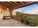 Enjoy breathtaking desert views from this covered balcony with terracotta tile and cozy seating at 10801 E Happy Valley Rd # 102, Scottsdale, AZ 85255
