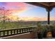 Expansive view from the covered balcony, showcasing the vibrant desert landscape during a colorful sunset at 10801 E Happy Valley Rd # 102, Scottsdale, AZ 85255