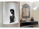 Powder room featuring black countertop, silver sink, and a decorative mirror above the sink at 10801 E Happy Valley Rd # 102, Scottsdale, AZ 85255