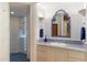 Bright bathroom featuring a tiled shower, blue-patterned countertop, and elegant blue-trimmed mirror at 10801 E Happy Valley Rd # 102, Scottsdale, AZ 85255