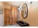 Modern bathroom with black sink and natural wood doors at 10801 E Happy Valley Rd # 102, Scottsdale, AZ 85255