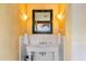 Bathroom featuring a vintage sink, decorative mirror, and sconce lighting at 10801 E Happy Valley Rd # 102, Scottsdale, AZ 85255