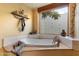 Bright bathroom with tiled tub and ornate wood decor at 10801 E Happy Valley Rd # 102, Scottsdale, AZ 85255