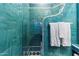 Bright bathroom showcasing blue tile, a glass shower door, and coordinated design elements at 10801 E Happy Valley Rd # 102, Scottsdale, AZ 85255