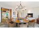 Open-plan dining room with fireplace, rustic stone floor and charming chandelier at 10801 E Happy Valley Rd # 102, Scottsdale, AZ 85255