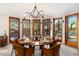 Bright dining room with floor-to-ceiling windows showcases desert views and leads to an outdoor patio and pool at 10801 E Happy Valley Rd # 102, Scottsdale, AZ 85255
