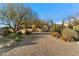 Long brick driveway leading to a custom home with desert landscaping in Arizona at 10801 E Happy Valley Rd # 102, Scottsdale, AZ 85255