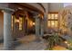 Covered patio with stone columns and an outdoor dining set at 10801 E Happy Valley Rd # 102, Scottsdale, AZ 85255