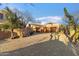 Custom home with a three-car garage, desert landscaping, and a brick driveway at 10801 E Happy Valley Rd # 102, Scottsdale, AZ 85255