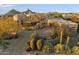 Desert property featuring beautiful landscaping, a paver driveway, and a charming entryway with a red door at 10801 E Happy Valley Rd # 102, Scottsdale, AZ 85255