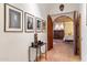 Hallway featuring tile floors, artwork, and an arched doorway leading to a bedroom at 10801 E Happy Valley Rd # 102, Scottsdale, AZ 85255