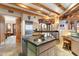 Spacious kitchen with an island, wooden beams, stainless steel appliances, and natural light at 10801 E Happy Valley Rd # 102, Scottsdale, AZ 85255