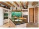 Elegant kitchen with wood beam ceilings, a center island, and stainless steel appliances at 10801 E Happy Valley Rd # 102, Scottsdale, AZ 85255