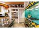 Cozy kitchen boasts colorful tiling, wood beam ceilings, stainless steel appliances, and stone floors at 10801 E Happy Valley Rd # 102, Scottsdale, AZ 85255