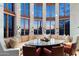 Open living space boasts walls of windows, a custom table, and designer furnishings at 10801 E Happy Valley Rd # 102, Scottsdale, AZ 85255