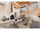 Open living room with beamed ceilings, stone floors, fireplace, and decorative accents at 10801 E Happy Valley Rd # 102, Scottsdale, AZ 85255