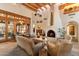 Spacious living room features beamed ceilings, a fireplace, and multiple seating areas at 10801 E Happy Valley Rd # 102, Scottsdale, AZ 85255