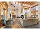 Spacious living room with beamed ceilings, stone floors, and a large fireplace at 10801 E Happy Valley Rd # 102, Scottsdale, AZ 85255