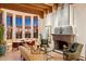 Inviting living room with a stone fireplace, beamed ceilings, and scenic views at 10801 E Happy Valley Rd # 102, Scottsdale, AZ 85255