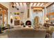 A living room with a fireplace, beamed ceilings, and art niches at 10801 E Happy Valley Rd # 102, Scottsdale, AZ 85255