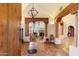 Inviting living room with beamed ceilings, a grand fireplace, tile flooring, and an open doorway at 10801 E Happy Valley Rd # 102, Scottsdale, AZ 85255