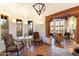 Spacious living room boasts beamed ceilings, tile flooring, and large windows with beautiful outdoor views at 10801 E Happy Valley Rd # 102, Scottsdale, AZ 85255
