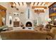 Elegant living room boasts a cozy fireplace, rustic wooden beams, and unique Southwestern decor accents at 10801 E Happy Valley Rd # 102, Scottsdale, AZ 85255