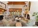 Living room with a fireplace, beamed ceilings, and an attached dining area at 10801 E Happy Valley Rd # 102, Scottsdale, AZ 85255