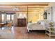 A cozy main bedroom features terracotta floors, wooden beam ceilings, and a beautiful canopy bed at 10801 E Happy Valley Rd # 102, Scottsdale, AZ 85255