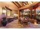 Charming outdoor dining space with stone flooring, wood beam ceiling, and a built-in grill, perfect for al fresco meals at 10801 E Happy Valley Rd # 102, Scottsdale, AZ 85255