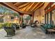 Inviting outdoor living area with a cozy fireplace, comfortable seating, and stone flooring for relaxation and entertaining at 10801 E Happy Valley Rd # 102, Scottsdale, AZ 85255