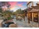 Charming outdoor patio with desert landscaping, a dining area, spa, and mountain views at 10801 E Happy Valley Rd # 102, Scottsdale, AZ 85255