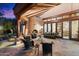 A cozy covered patio features a fireplace, comfortable seating, and stone flooring at 10801 E Happy Valley Rd # 102, Scottsdale, AZ 85255