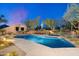 Desert home featuring a private pool, rock waterfall, and ample lounge seating, perfect for outdoor relaxation at 10801 E Happy Valley Rd # 102, Scottsdale, AZ 85255