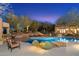 A luxurious backyard pool has a baja deck, desert landscaping, and an adjacent lounging area at 10801 E Happy Valley Rd # 102, Scottsdale, AZ 85255