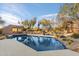 Relaxing pool featuring desert landscaping, comfortable lounge chairs, and a built-in seating area for outdoor enjoyment at 10801 E Happy Valley Rd # 102, Scottsdale, AZ 85255